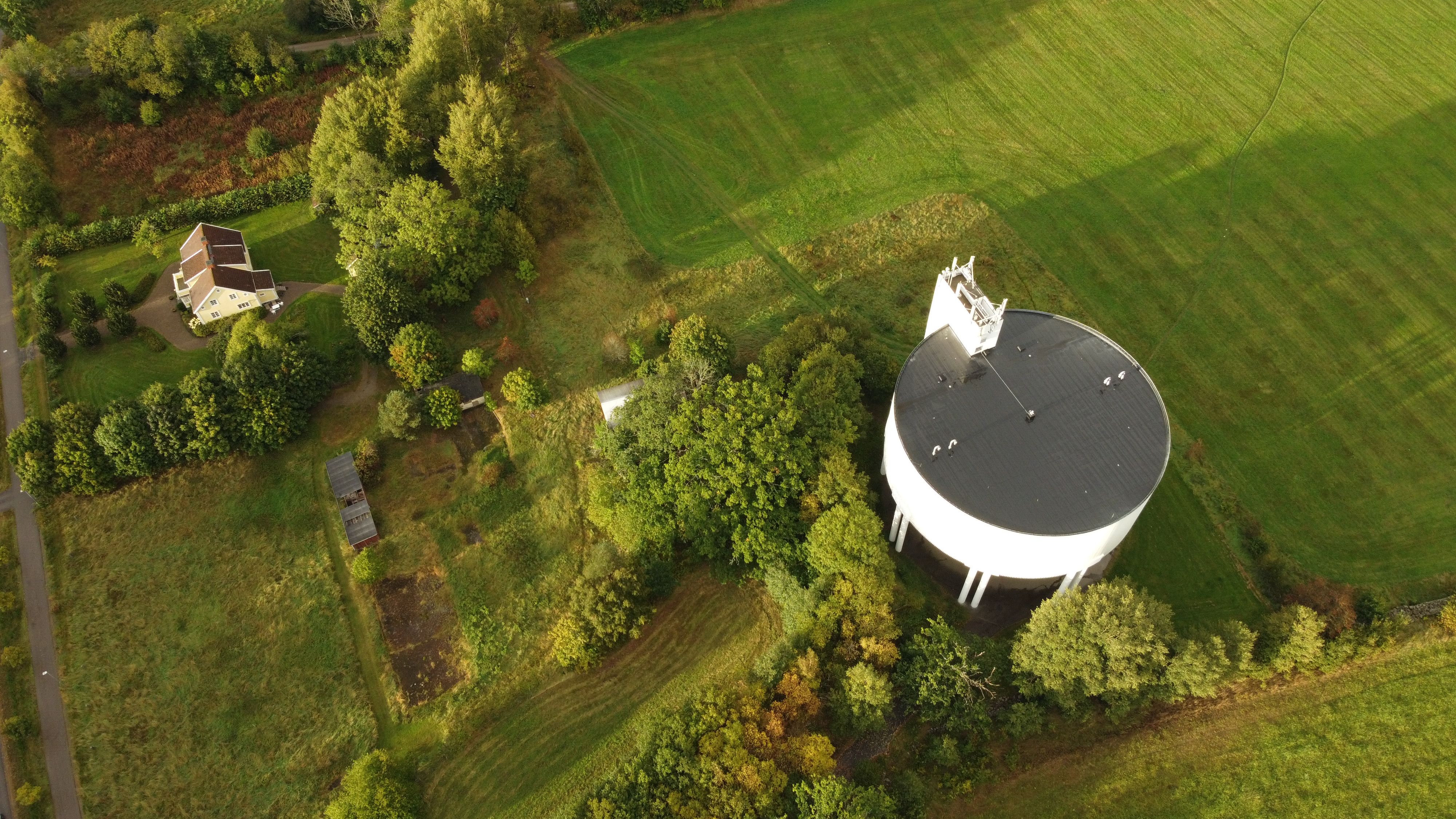 Aerial view of a remote property beside a large water storage facility